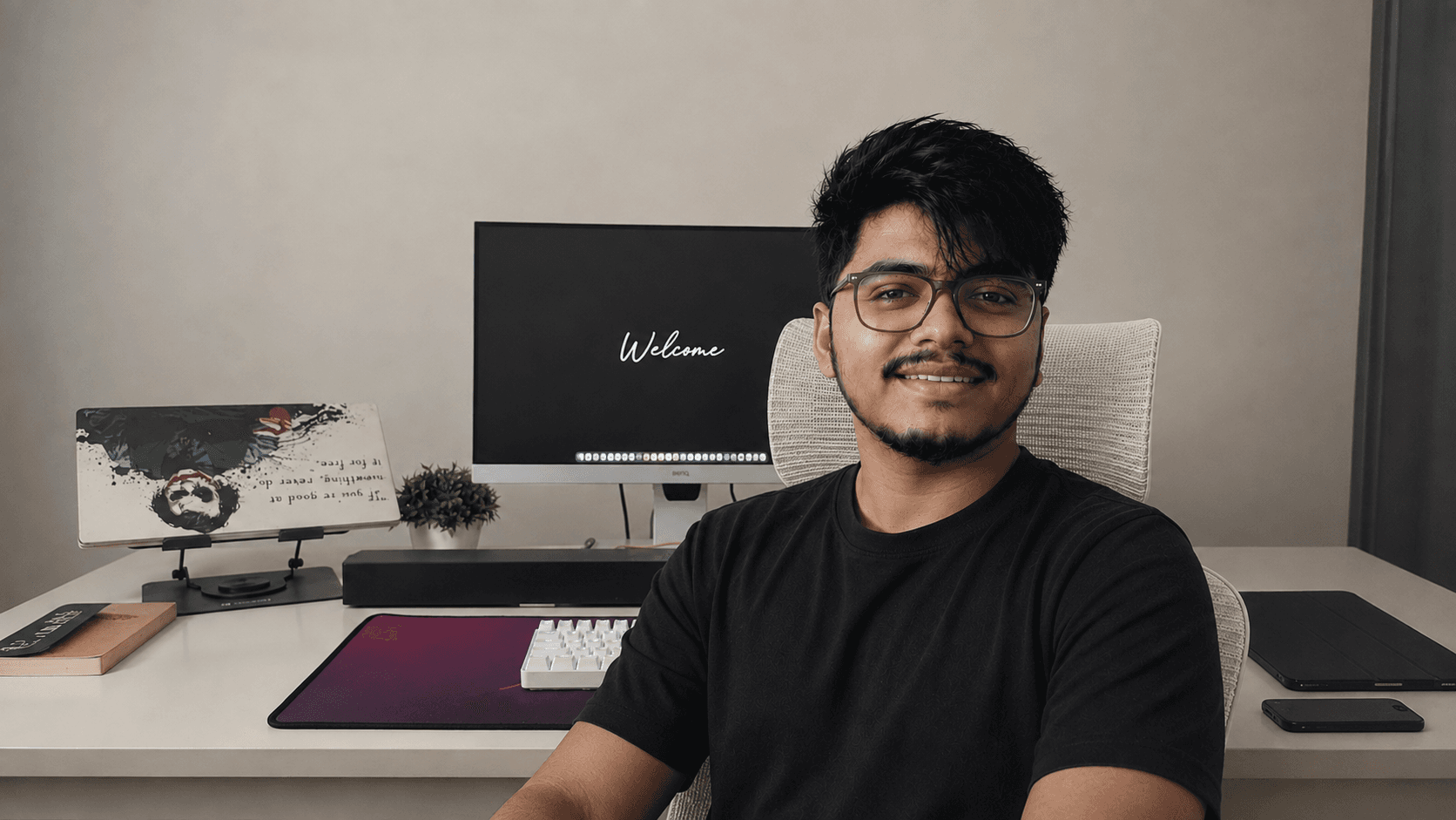 Tamal Biswas at his desk, a monitor and keyboard behind him
